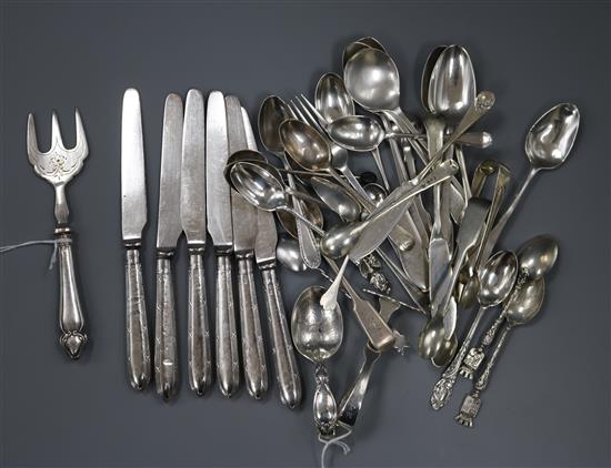 A silver spoon and pusher, a collection of small silver flatware, six silver-handled butter knives and a pickle fork,